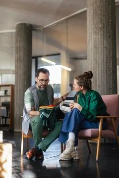 Interior designers considering, selecting colours, patterns, designs of fabrics. 写真素材