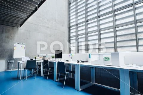 An interior of desks with computer in modern spacious office. Stock-Fotos