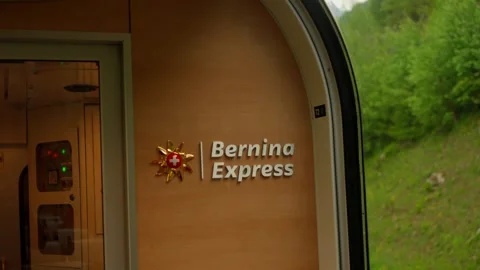 Interior detail of Bernina Express train car featuring official logo and Swiss Stock Footage 331113150