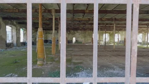 Interior of dilapidated building, backwards view indoors to outdoors Stockbeeldmateriaal 279872236