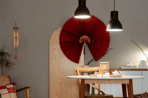 Interior of dining room with table, Asian decor and glowing lamps in evening Stock Photos