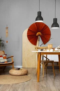 Interior of dining room with table, Asian decor and lamps Stock Photos