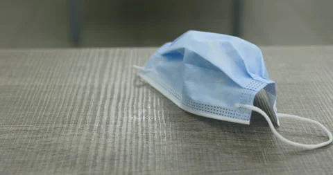 Interior, dolly left, table, surgical mask, hand, flick, relief Stock Footage 236882273