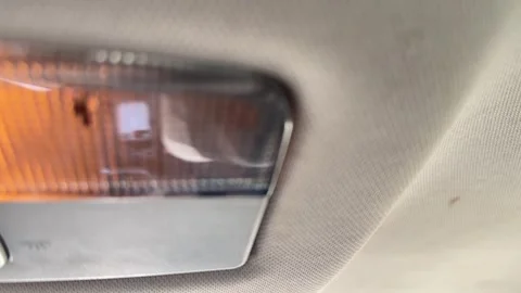 Interior dome light turns on and off inside a car, close-up of the ceiling lamp, Stock Footage 337113738