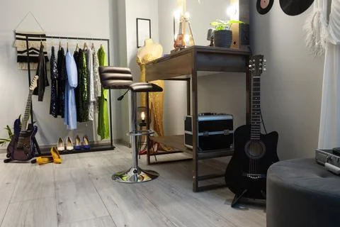 Interior of dressing room with guitars, makeup table and clothes Stock Photos