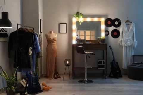 Interior of dressing room with guitars, makeup table and clothes Stock Photos