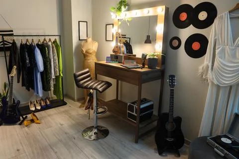Interior of dressing room with guitars, makeup table and clothes Stock Photos