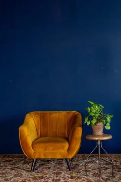 Interior element, yellow empty armchair against blue wall background, copy space Stock Photos