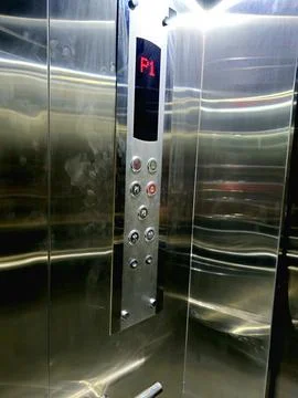 The interior of an elevator, its cab typically features wall panels, a car .. Stock Photos