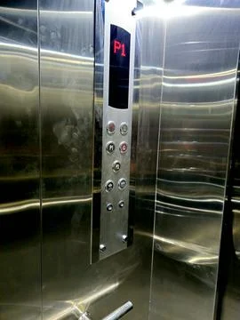 The interior of an elevator, its cab typically features wall panels, a car .. Stock Photos