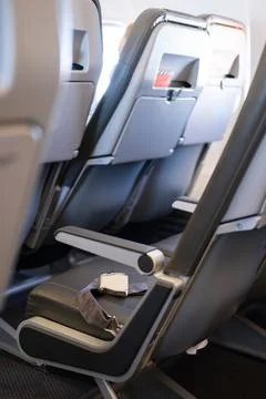 Interior of an empty airplane. Empty aircraft seats with seat belts Stock Photos
