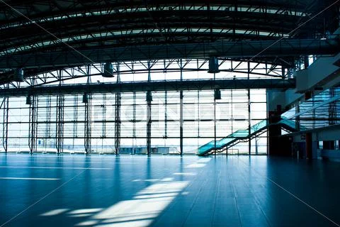 Interior of empty airport terminal with glass wall Stock Photos