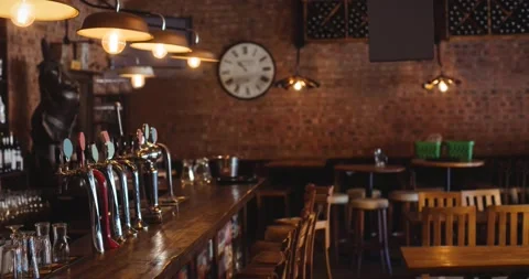 Interior of empty bar or pub, with beer taps, wooden tables and chairs and Stock Footage 165607229