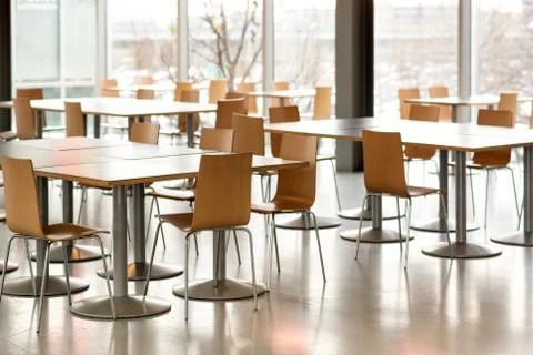 Interior of empty canteen with tables and chairs Foto stock