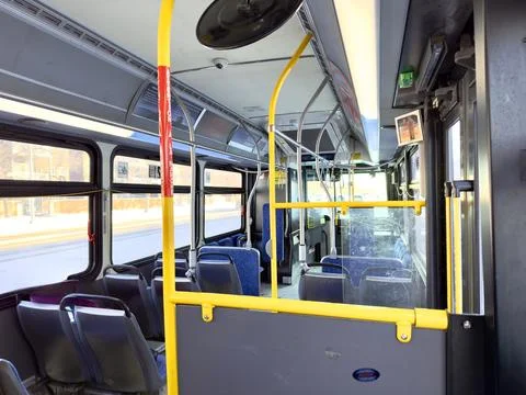 Interior of empty city bus with blue seats Foto stock