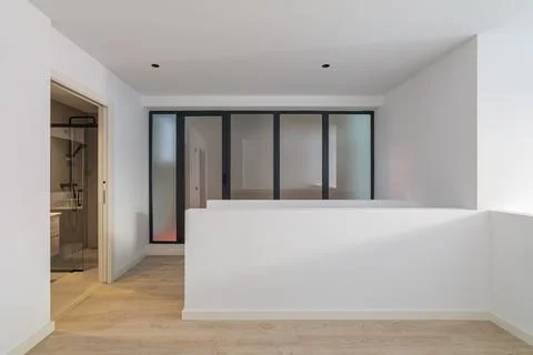 Interior of empty flat with doorway to bathroom. White and clean room in Stock Photos