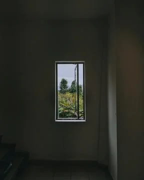 The interior of an empty house with a small window and tiled floor, French villa Stock Photos