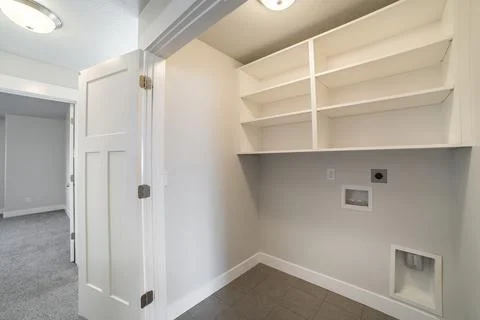 Interior of an empty laundry room with folding door Stock Photos