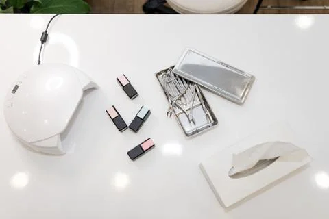 Interior of empty modern nail and beauty salon. Long table with lamp, manicur Stock Photos