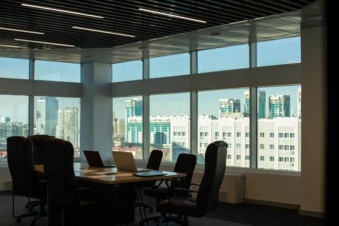 The interior of an empty modern office with a table and chairs and a meeting Stock Photos