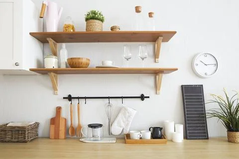 Interior of empty modern white kitchen with various objects on the table Stock Photos