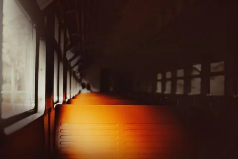 The interior of an empty old retro train with orange seats in the evening. Tr Stock Photos