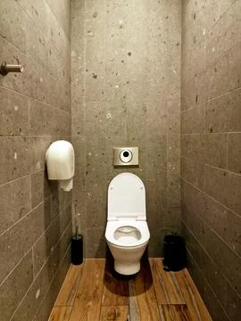 Interior of empty public restroom. Open toilet bowl, wc Stock Photos