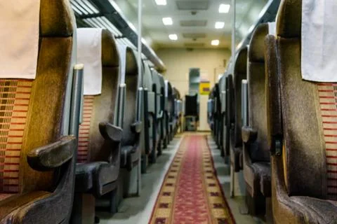Interior of the empty railroad car with comfortable seats Stock Photos