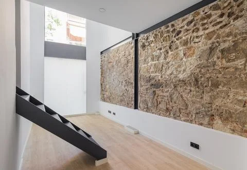 Interior of empty renovated room in a duplex flat. Mix of new and old Stock Photos