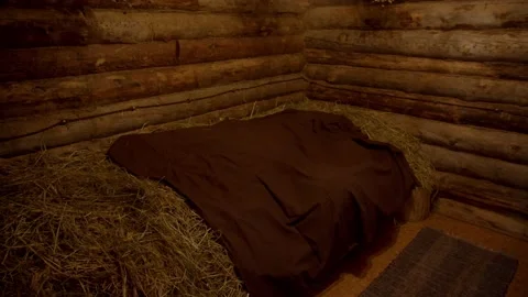 Interior of empty rest room is bed made of hay bales covered with sheet and Stock Footage 221938869