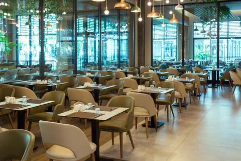 Interior of an empty restaurant hall with large windows Stock Photos