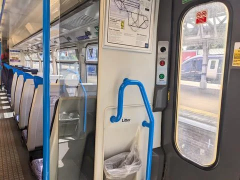 Interior of an empty Southeastern commuter train carriage with blue seats at Stock Photos