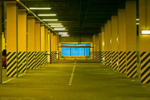 Interior of empty underground parking garage at night Stock Photos