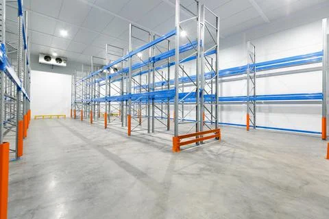 Interior of empty warehouse with empty racks Stock Photos