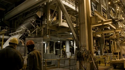 Interior Factory - 2 workers reviewing robotic controls - Wide Shot - Pan Stock Footage 89944209