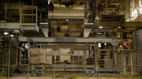 Interior Factory - Worker and rolled steel fabrication machine - Wide Shot - Stock Footage 89944217