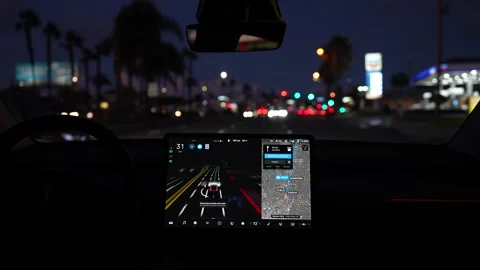 Interior of fully autonomous Tesla electric car in autopilot mode Stock Footage 166936710