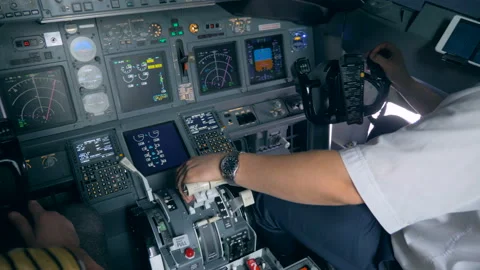 Interior of a functioning airplane cockpit with pilots sitting in it Stock Footage 93660230