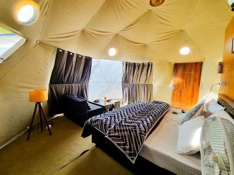 Interior of geodesic, triangular and swiss tents at a popular glamping spot.. Stock Photos