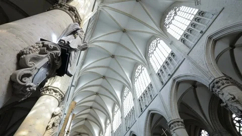 Interior of gothic cathedral in Brussels with people sitting inside. Stock Footage 89185519