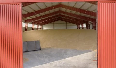 Interior of Grain Storage Facility Featuring Red Walls and Stockpiled Harve.. Photos