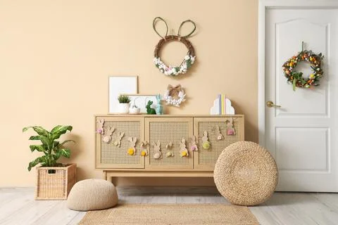 Interior of hallway with commode, ottomans, paper rabbits garland and Easter  Stock Photos