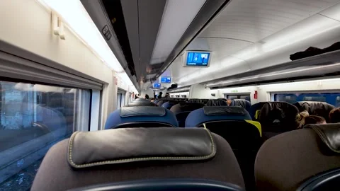 Interior of a high-speed train carriage featuring rows of seats windows and 動画素材 330921960