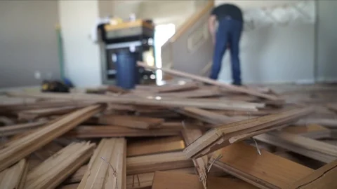 Interior home renovations construction workers ripping up hardwood floor Stock-Footage 127476855
