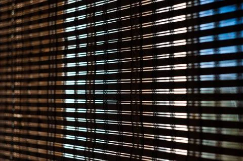 The interior of the home, sunlight shining through the bamboo blinds at the w Stock Photos