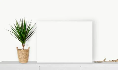 Interior horizontal rectangular poster mockup standing on the table with plan Stock Photos