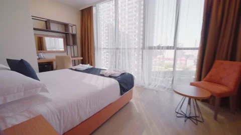 Interior of hotel has large bed and windows in floor. Flight camra across room. Video stock 196151934