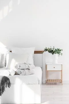 Interior of hotel room with bed, folded bathrobes and table Stock Photos