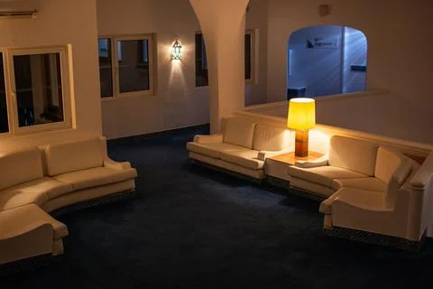 Interior of a hotel room with white sofas and lamps, Hotel Lobby at Night Stock Photos