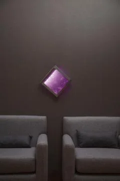 Interior of a house with two symmetrical sofas and a picture of purple minera Stock-Fotos